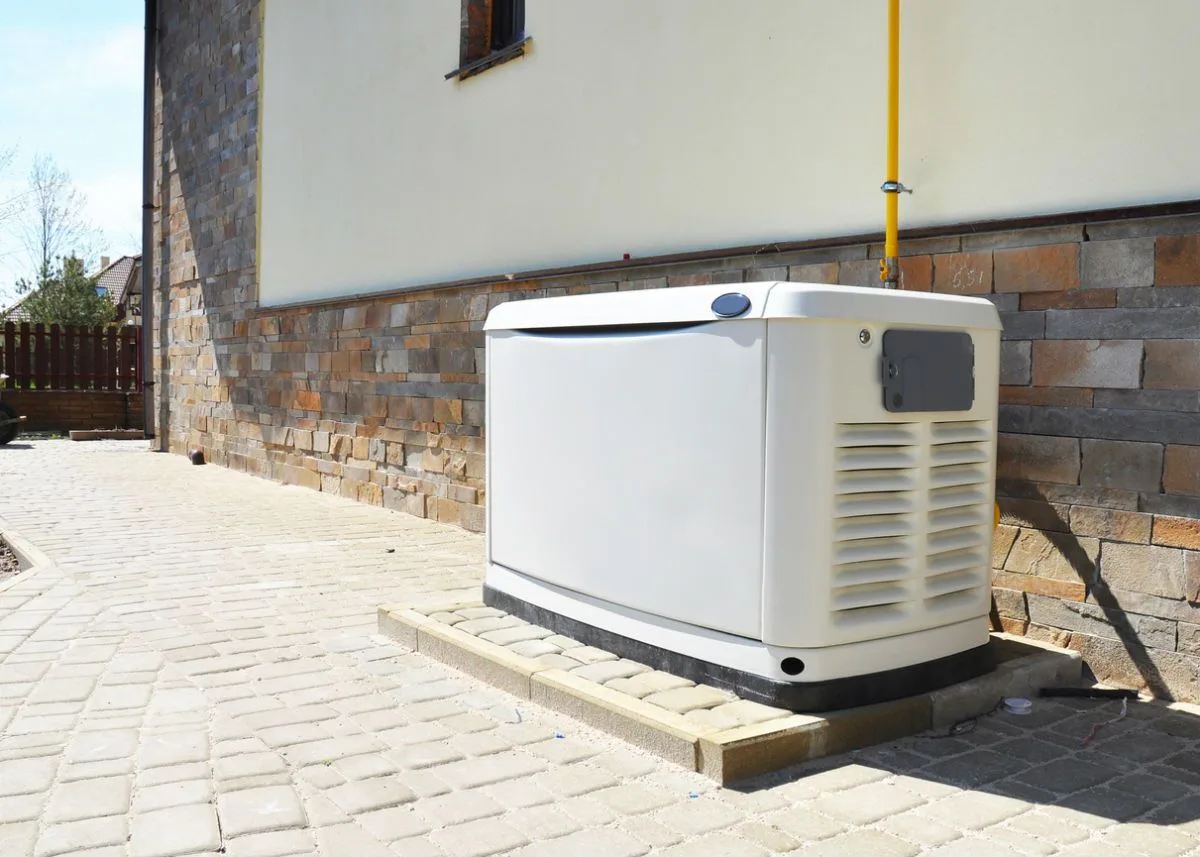 Whole-home standby generator beside a residence